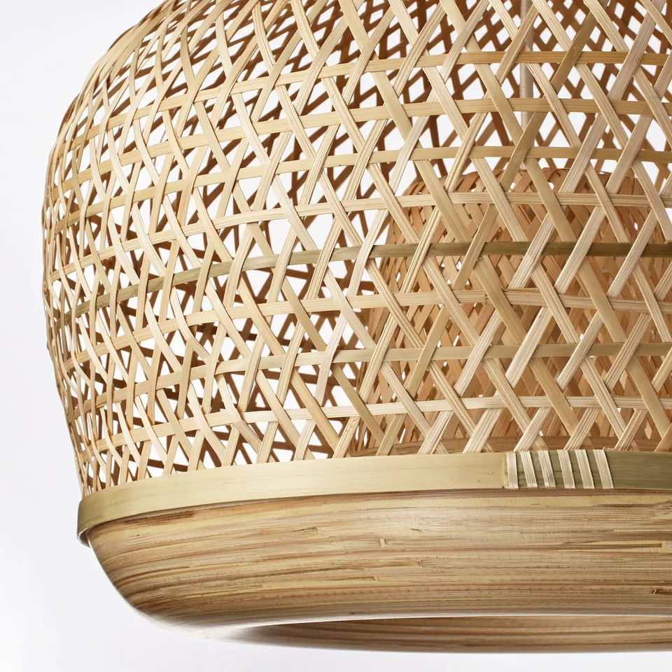 Handwoven bamboo pendant lamp with intricate lattice pattern, natural variations, and warm, soft glowing light.