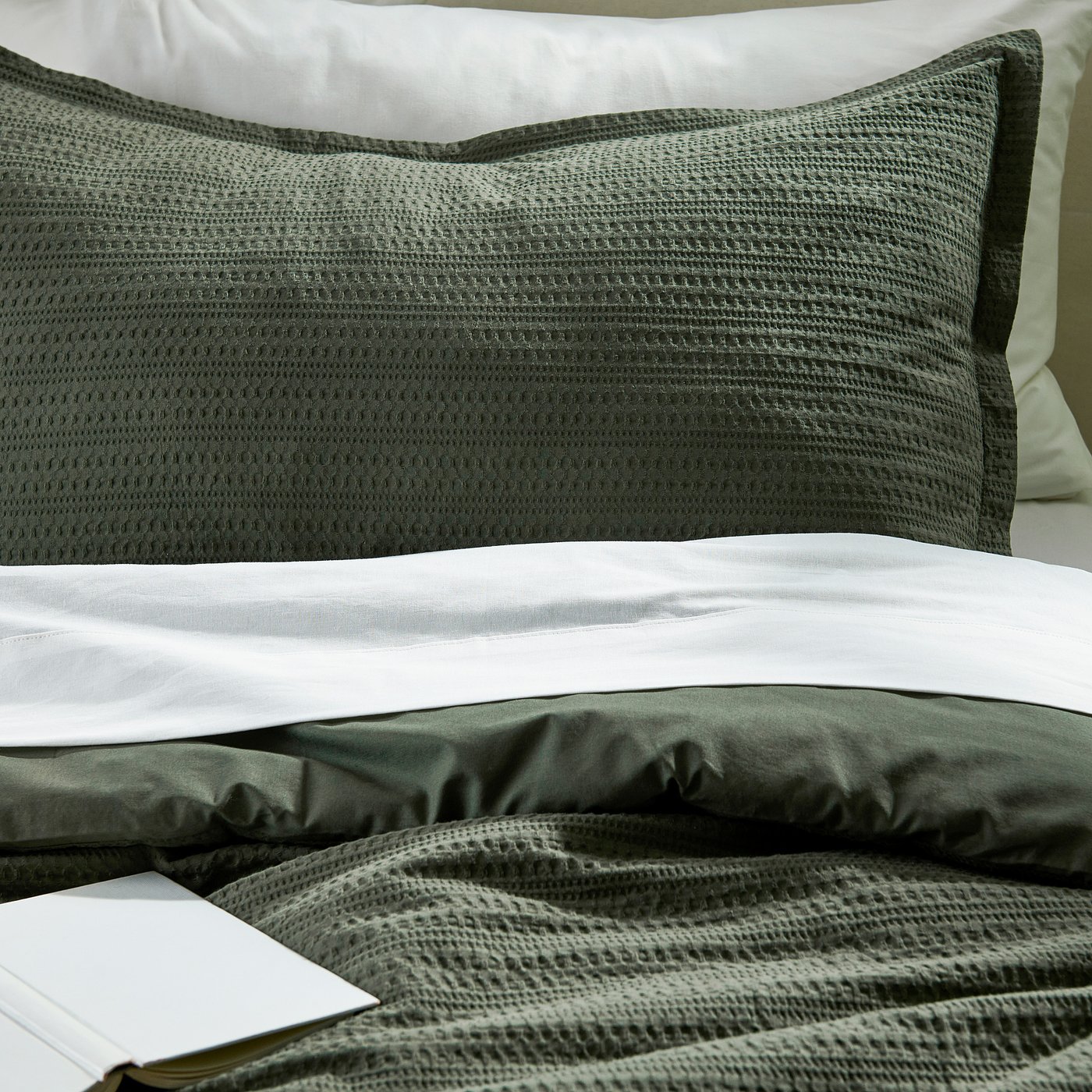 Cosy green bedding set with plush, textured comforter and matching pillow sham, inviting and warm.
