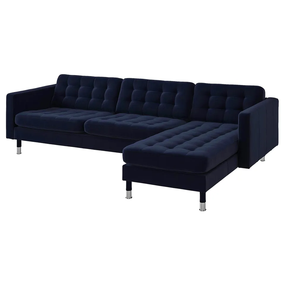 Dark blue, modern l-shaped velvet sofa with chrome legs, tufted seats, and adjustable armrests.