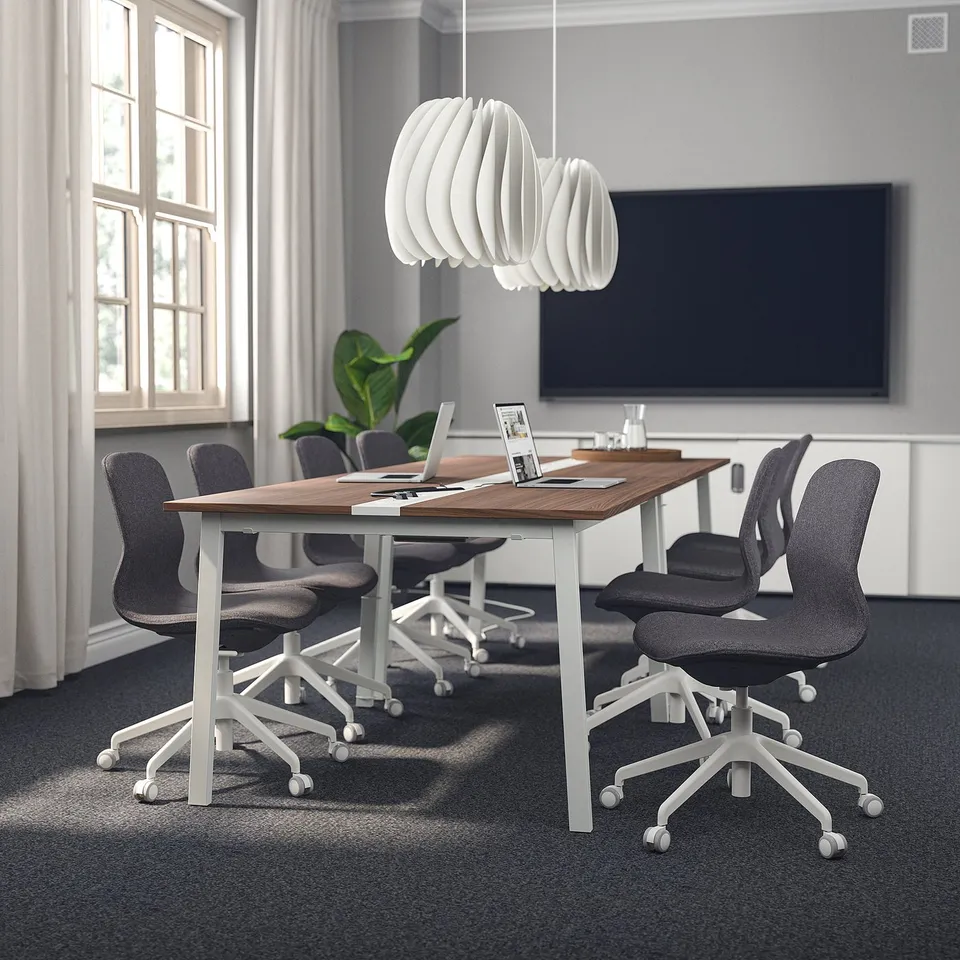 Modern conference room with MITTZON tables, långfjäll chairs, and a mounted tv with headphones.