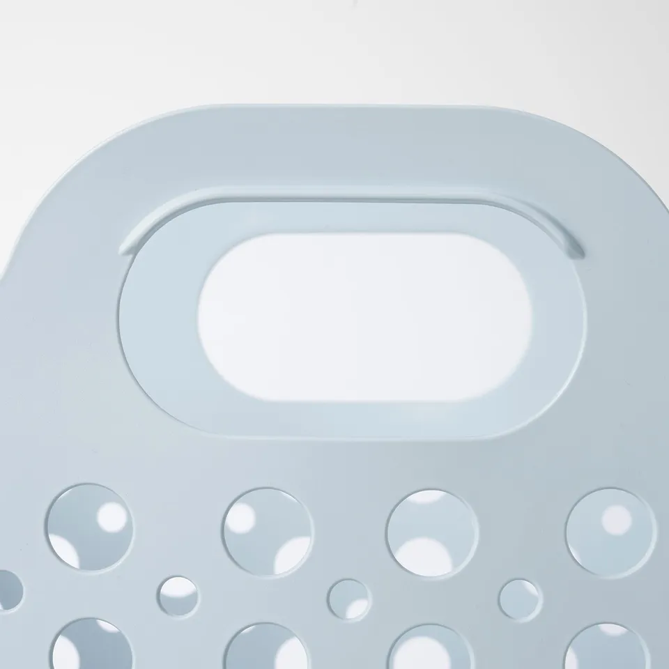 Light blue plastic laundry basket, cutouts for aeration, durable flexible material.