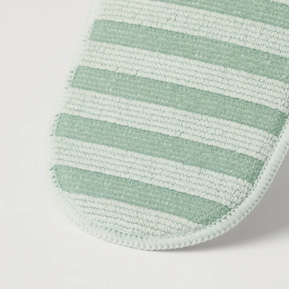 Close-up of green and white striped PEPPRIG microfiber pad, showcasing quality texture and design.
