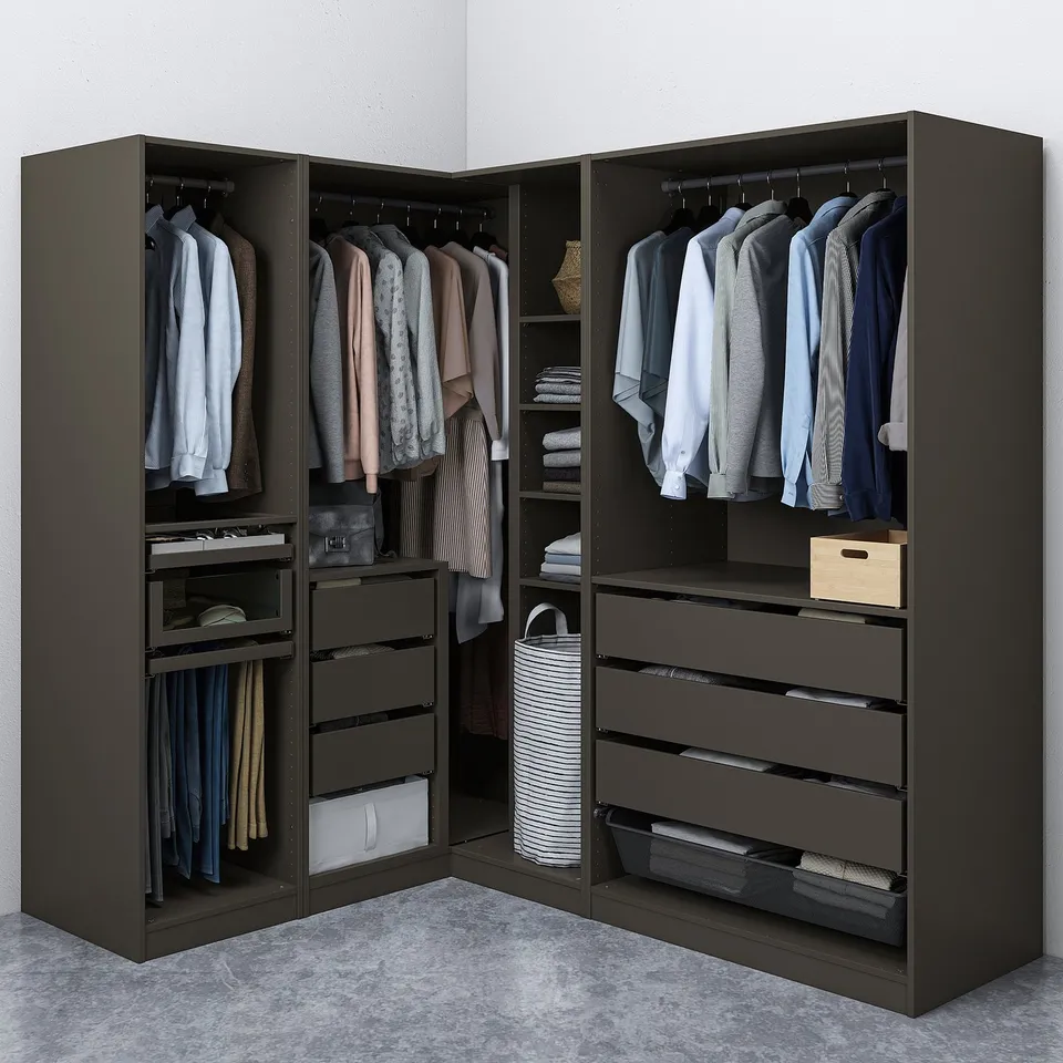 Dark corner wardrobe with hangers, shelves, and drawers organised with clothes and accessories, featuring mesh baskets for storage.