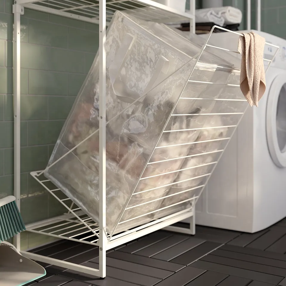 Outdoor white metal storage rack with mesh bags holds laundry, showcasing organised, modern design.