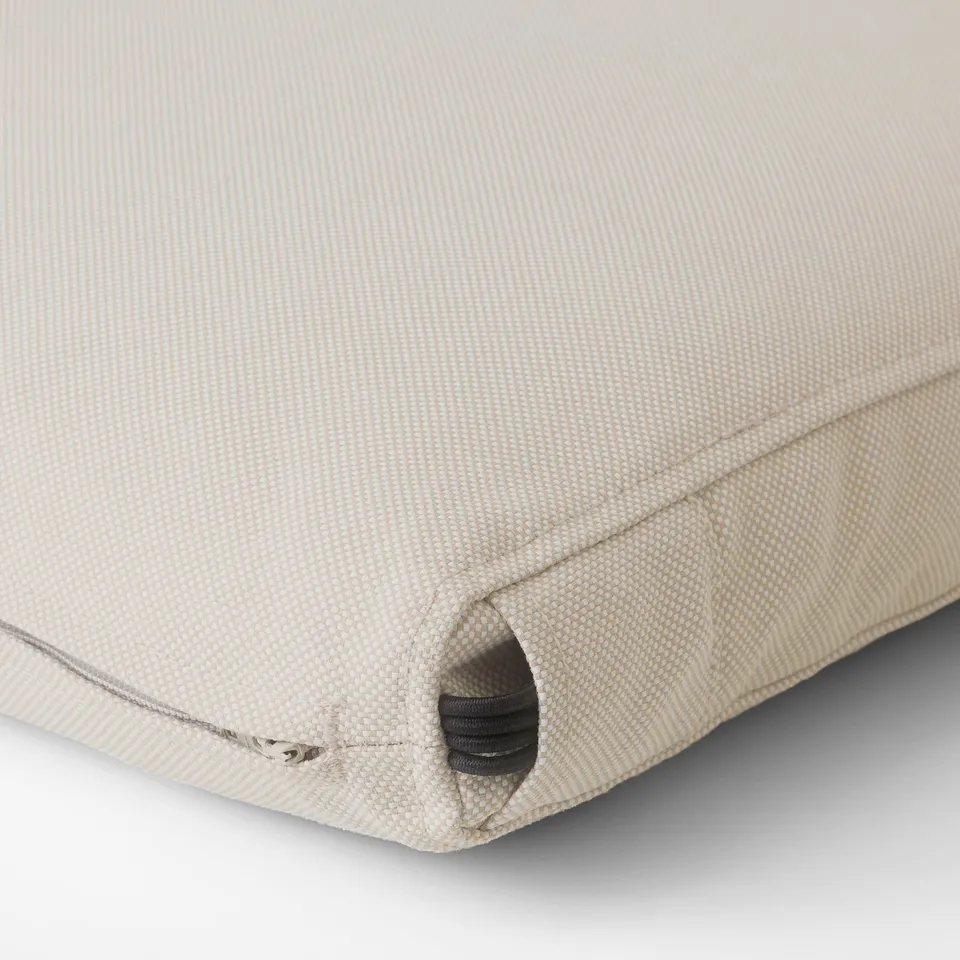 Close-up of frösön cushion cover, light beige, textured fabric, shows zip detail.