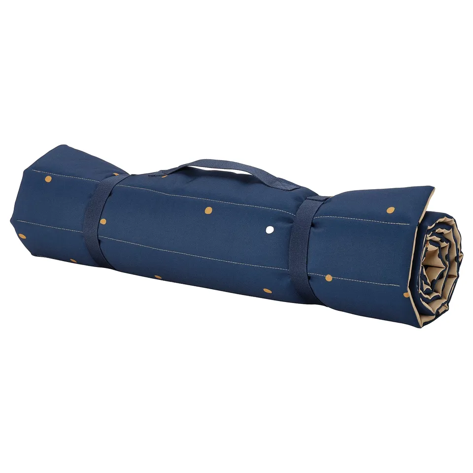 Savannah-themed blue roll-up picnic mat with yellow dots and handles.