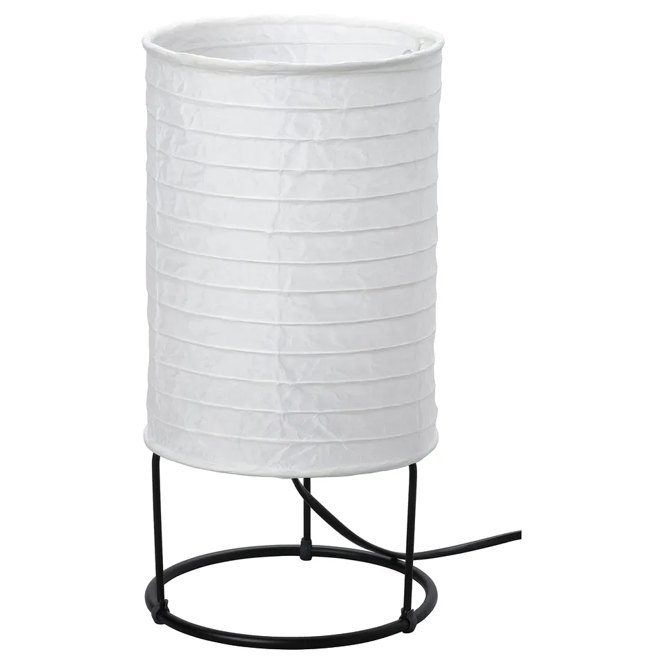 A STRANDAD table lamp, featuring a white rice paper shade, round black metal base, and diffuser.