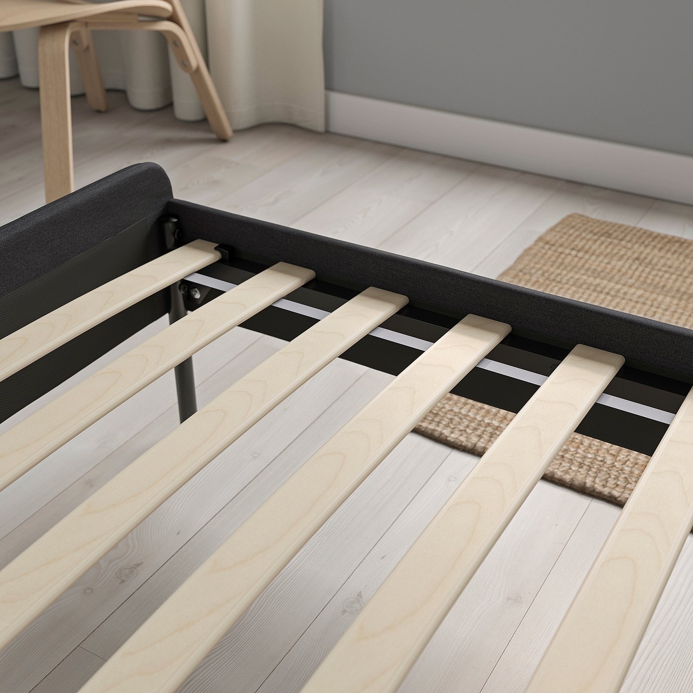 Wooden slats on bed frame, padded headboard visible, showcasing support and comfort design.