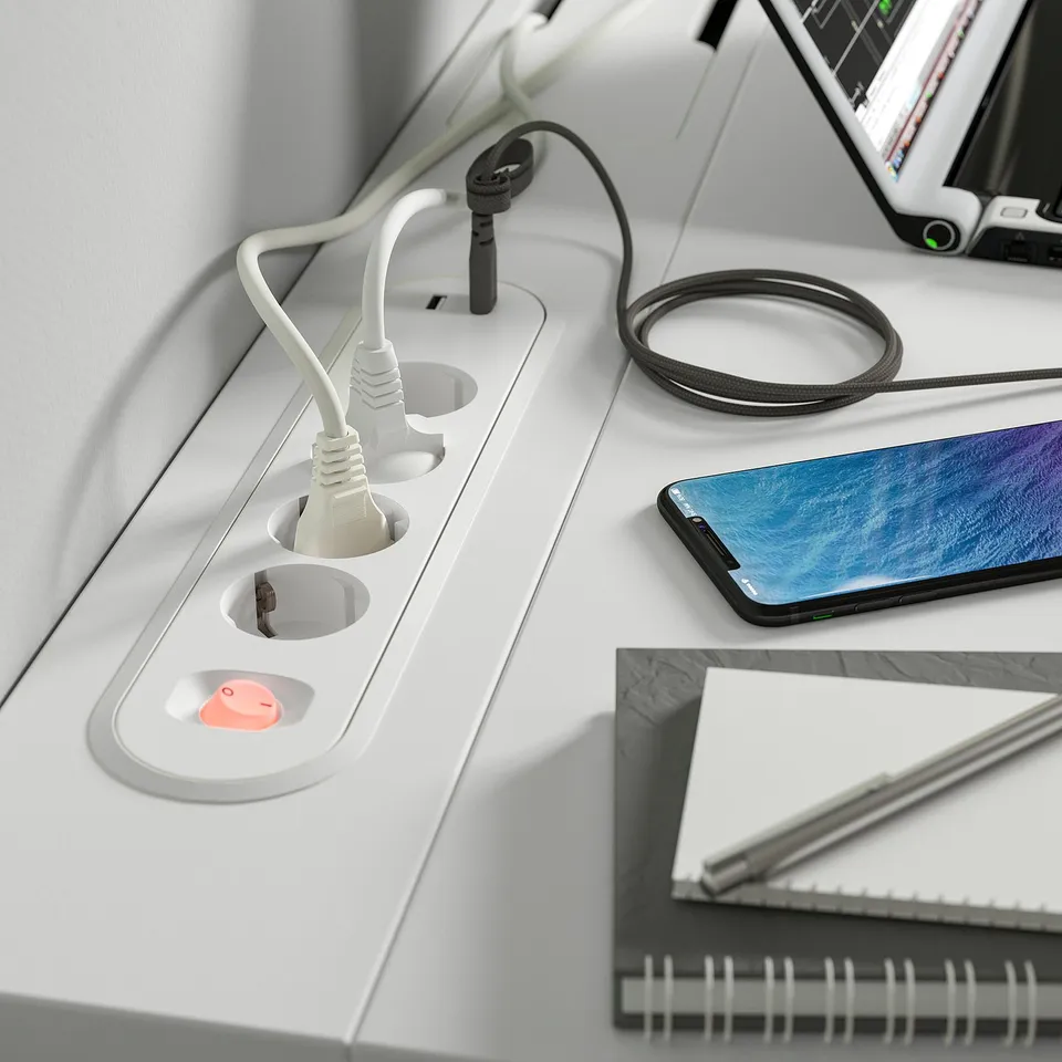 Desk with built-in power sockets and a cable management tray, ensuring a clutter-free workspace.