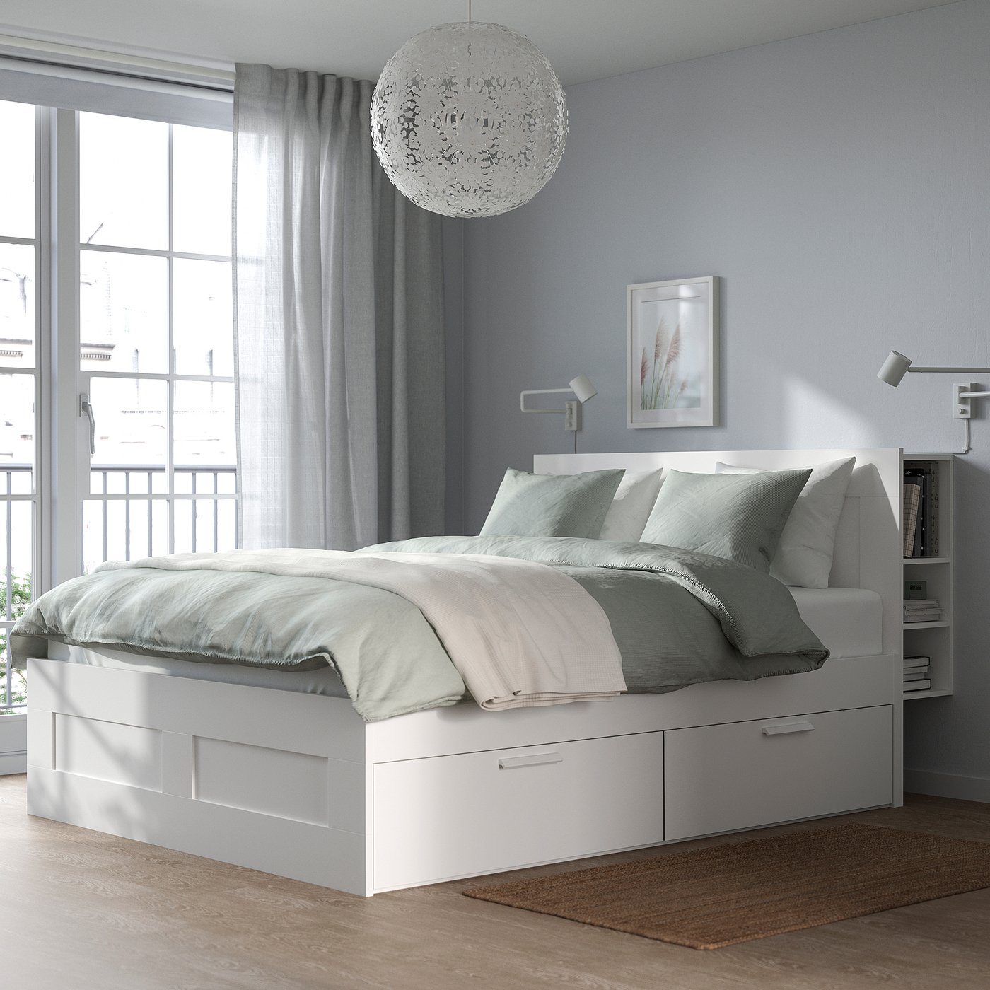 Modern white BRIMNES bed with storage and large hanging light.