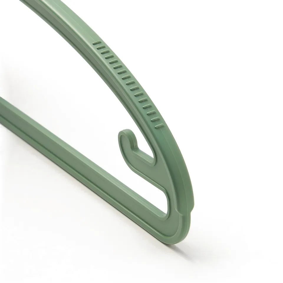Close-up of SLIBB hangers sturdy, eco-friendly green plastic, showing smooth edges and anti-slip grooves.