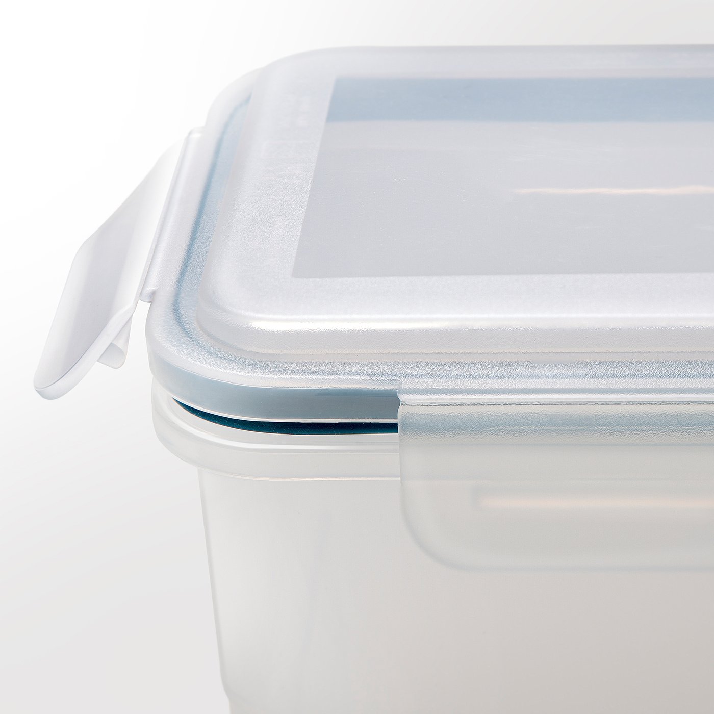 Close-up of clear plastic food jar with secure lid and silicone seal, showing quality details.