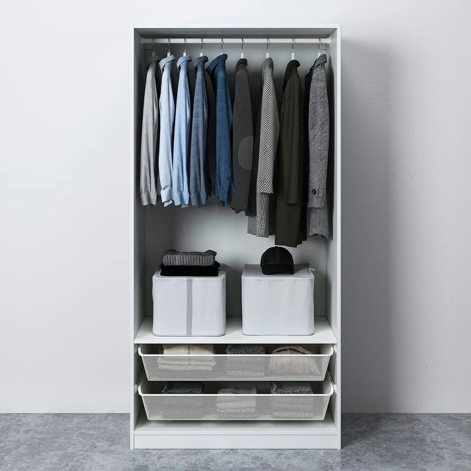 Open wardrobe with hanging shirts, folded clothing in boxes, and mesh basket drawers at the bottom.