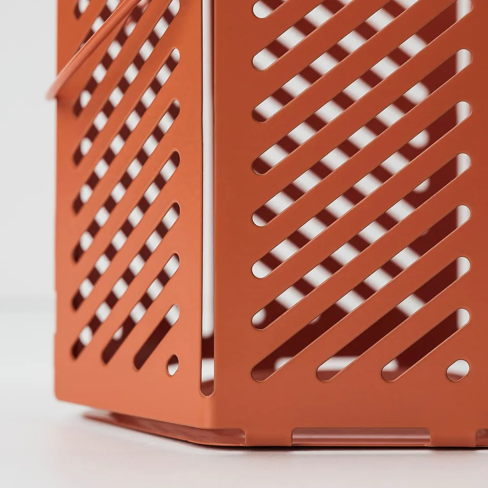Bright orange, slatted metal lantern. Even slats and smooth edges, high quality.
