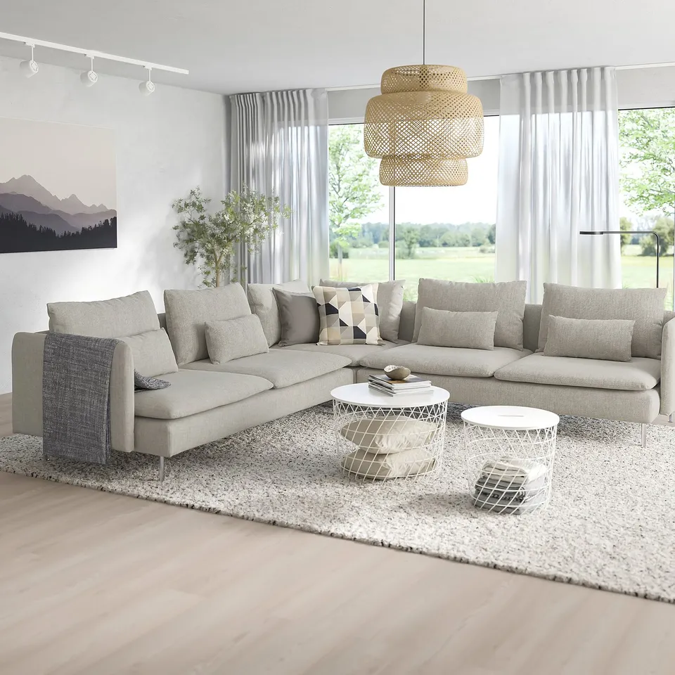 Modern living room with large white SÖDERHAMN sectional, soft cushions, coffee table, and large windows.