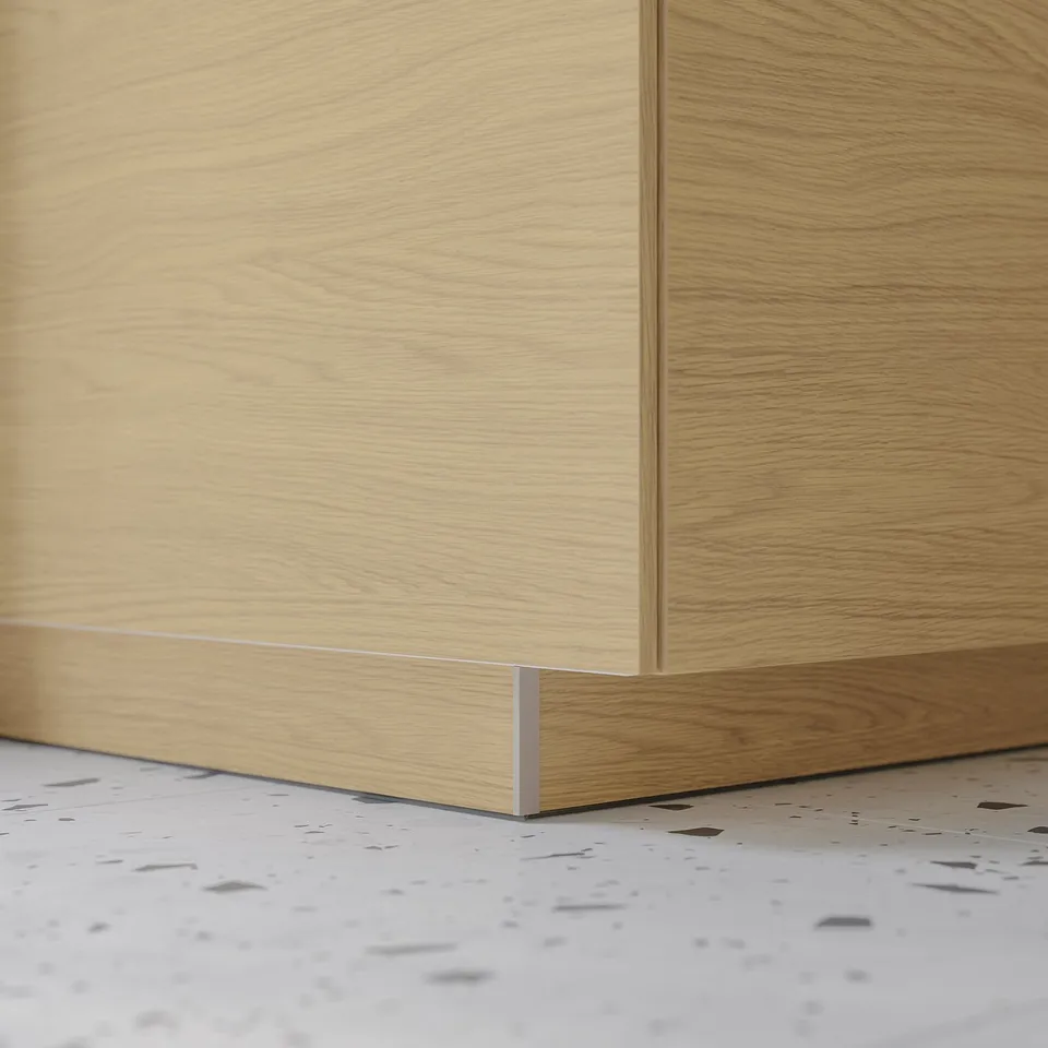 A light wooden kitchen plinth in a sleek design.