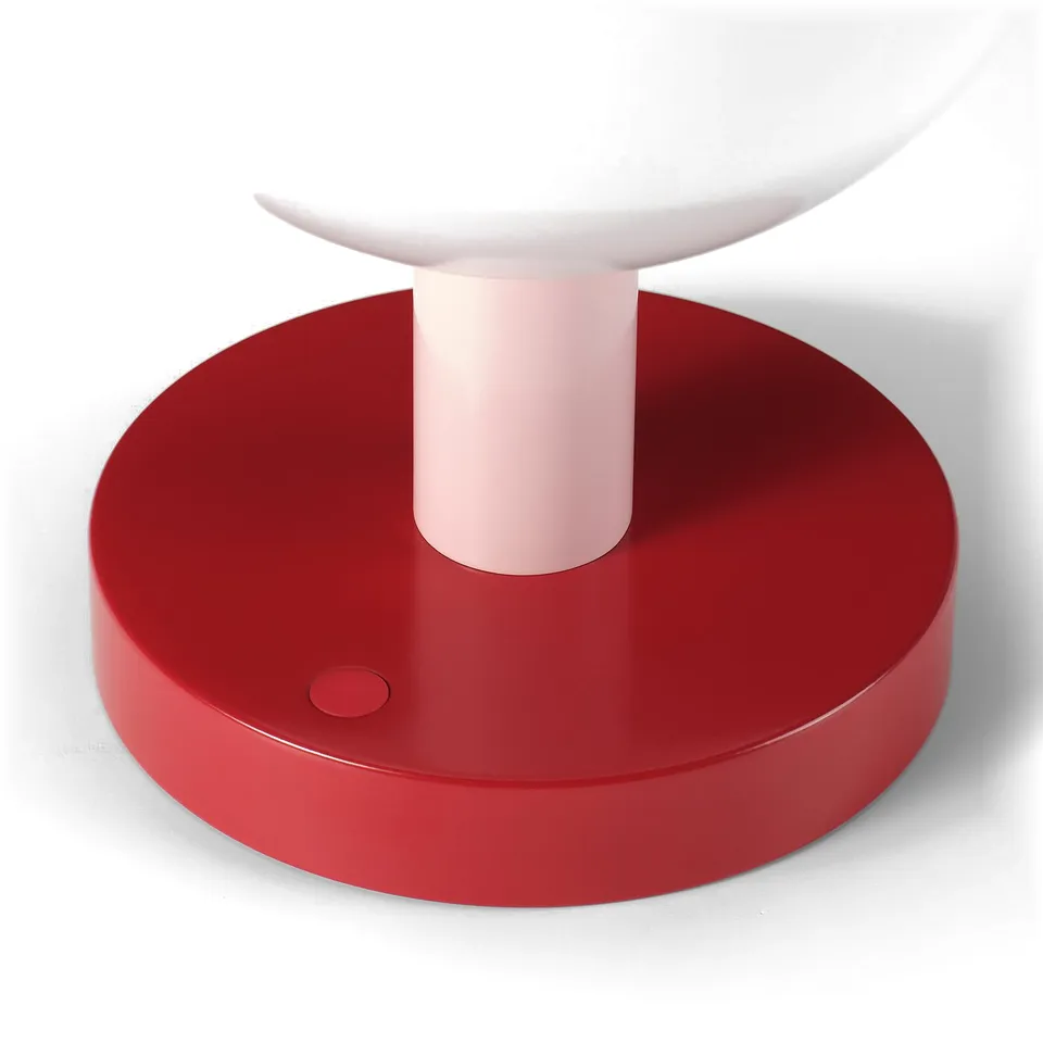 Modern table lamp with red base, pink tube, white shade. Minimalist design, high-quality materials.