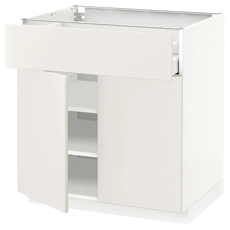 Depicts a white METOD kitchen cabinet with a single drawer and open shelf. Modern and minimalist design, it a smooth finish and sturdy construction.