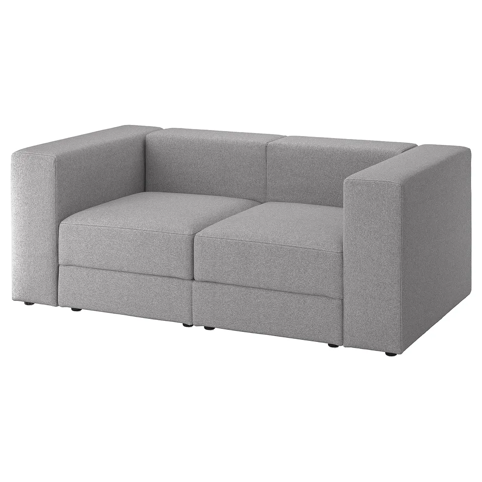 A small, light grey sofa named JÄTTEBO with a sleek, modern design and soft, rectangular cushions.