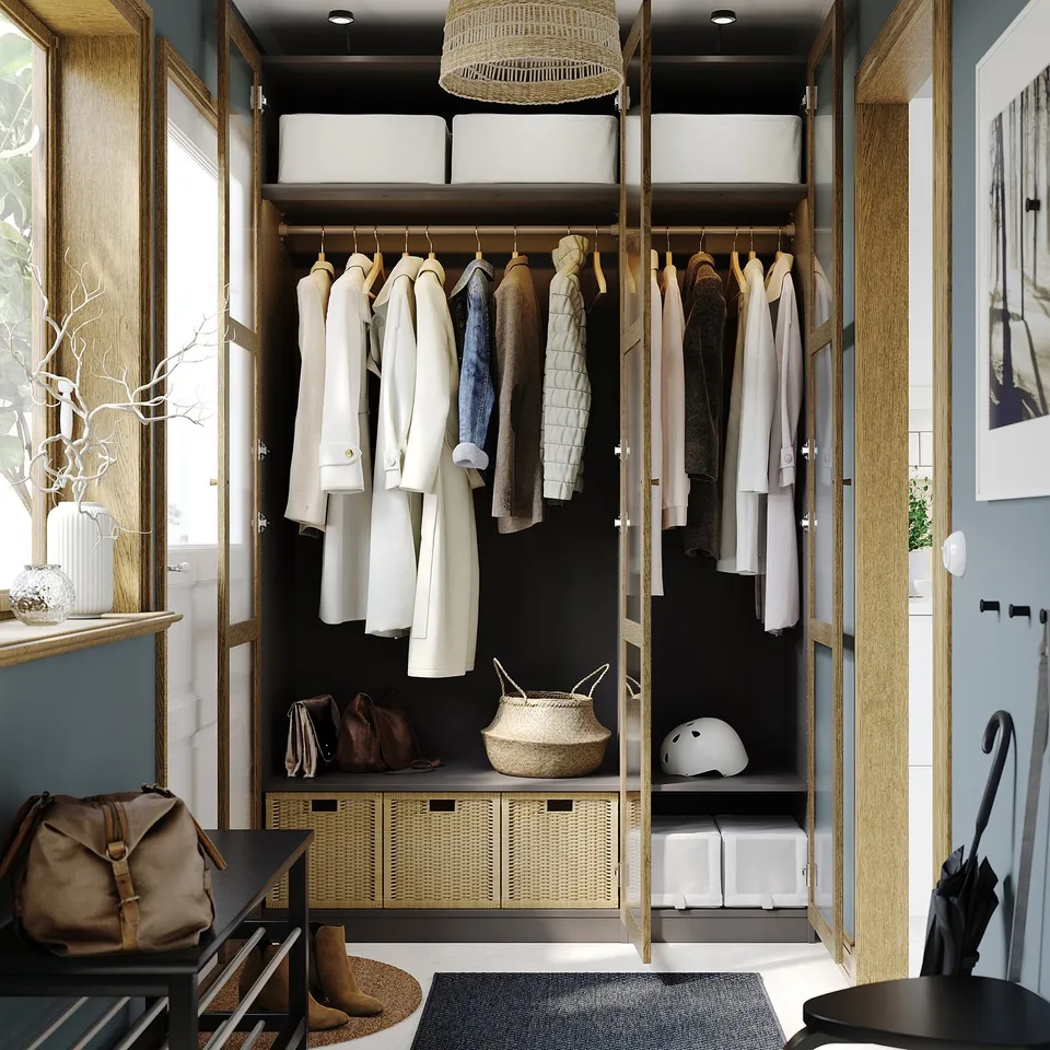 Walk-in closet with clothes, bags, and helmet, featuring adjustable feet, dampened hinges, and integrated lighting.