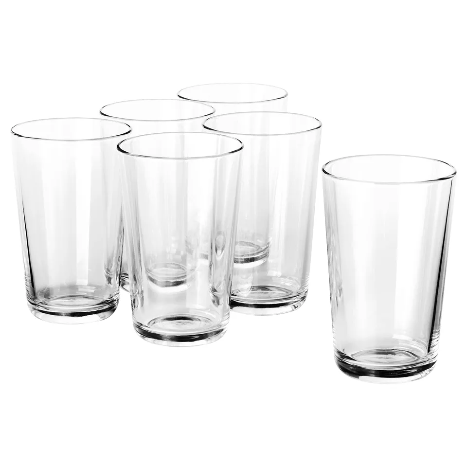 Six clear, tempered glass tumblers in various sizes by IKEA 365+, neatly arranged on a white background, showcasing their sleek and simple design.