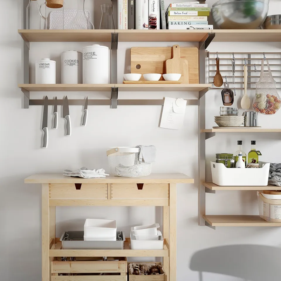KUNGSFORS magnetic knife rack holds knives horizontally between kitchen shelves.