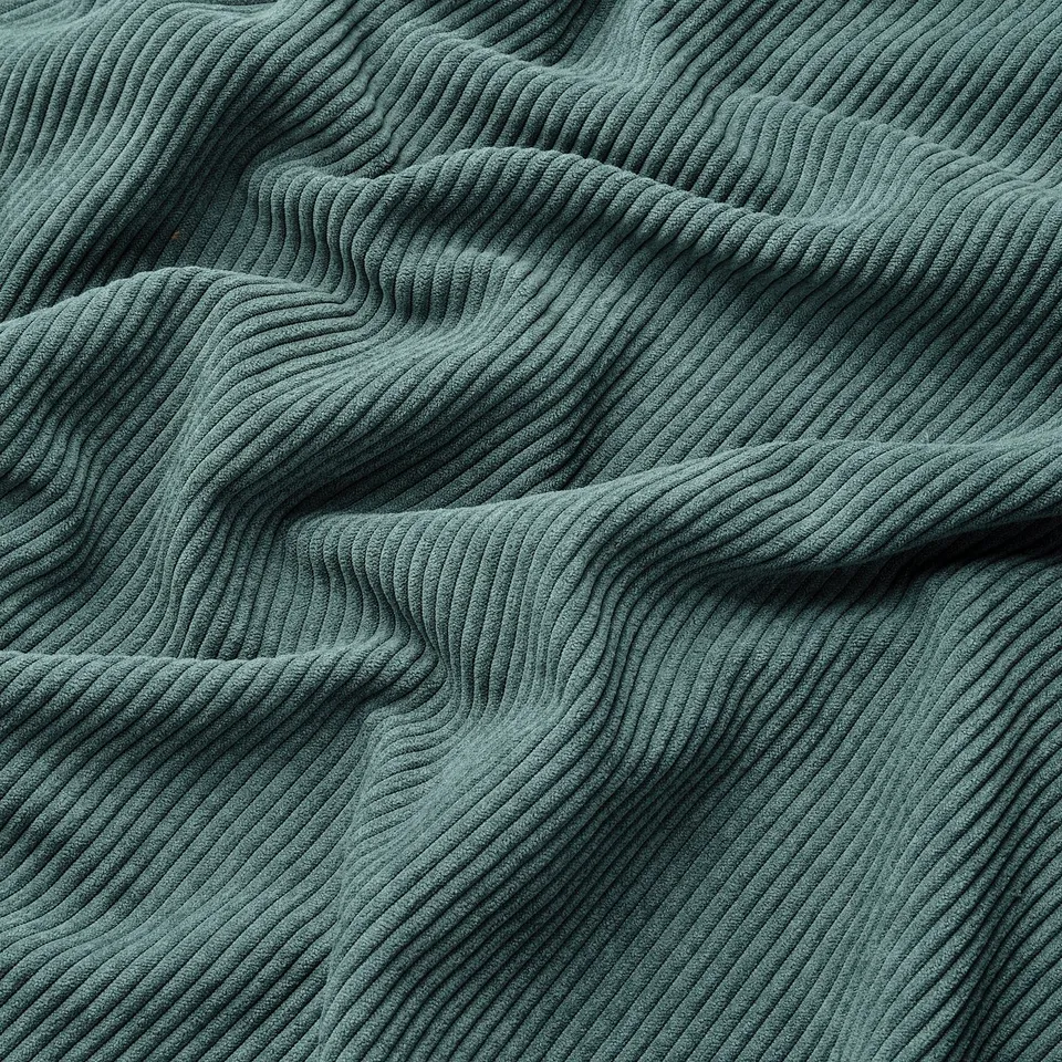 Soft, thick, green corduroy fabric, slightly shiny, folded texture.