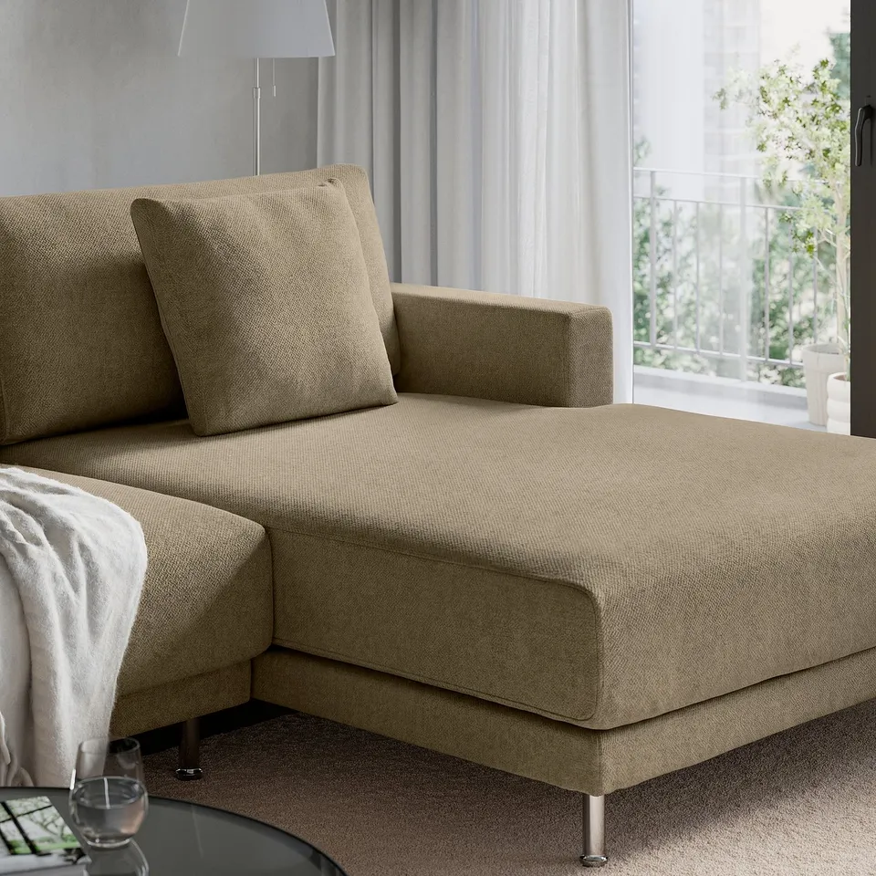 A beige UPPÅKRA sofa with a pillow, glass, and remote on a table nearby.