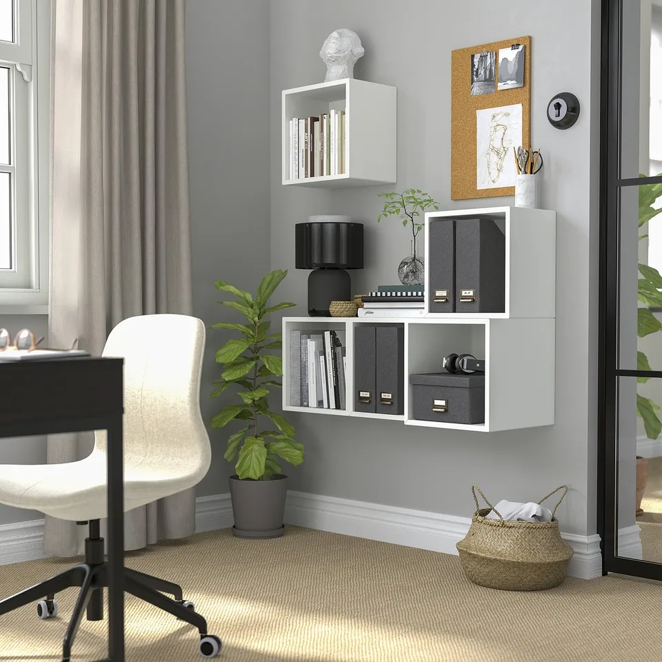 Home office with EKET shelves, desk, chair, plant, and basket.