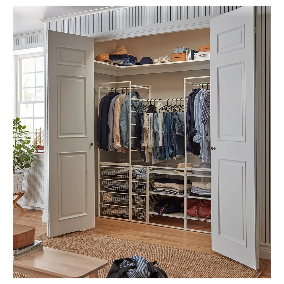 Open closet with JONAXEL white steel organisers, clothes hangers, and shelves neatly storing garments and accessories.