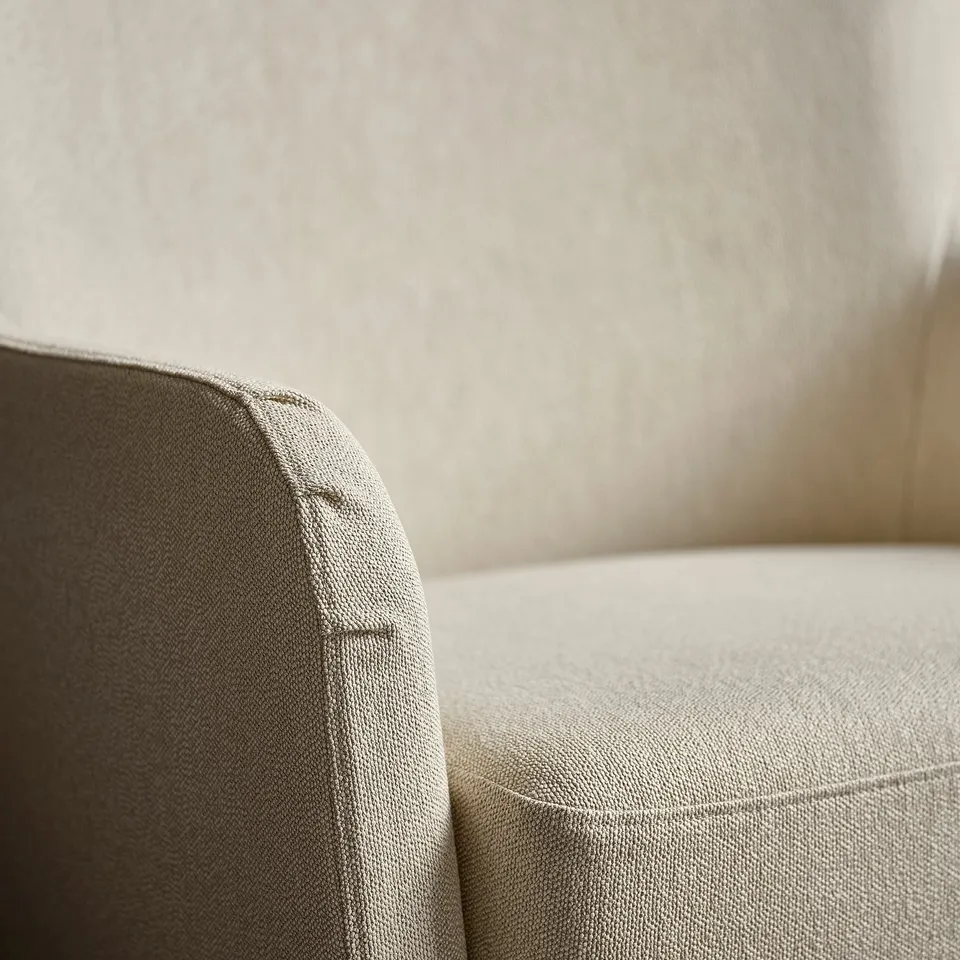 Close-up of armchairs upholstered, high back showcasing clean lines and soft fabric.