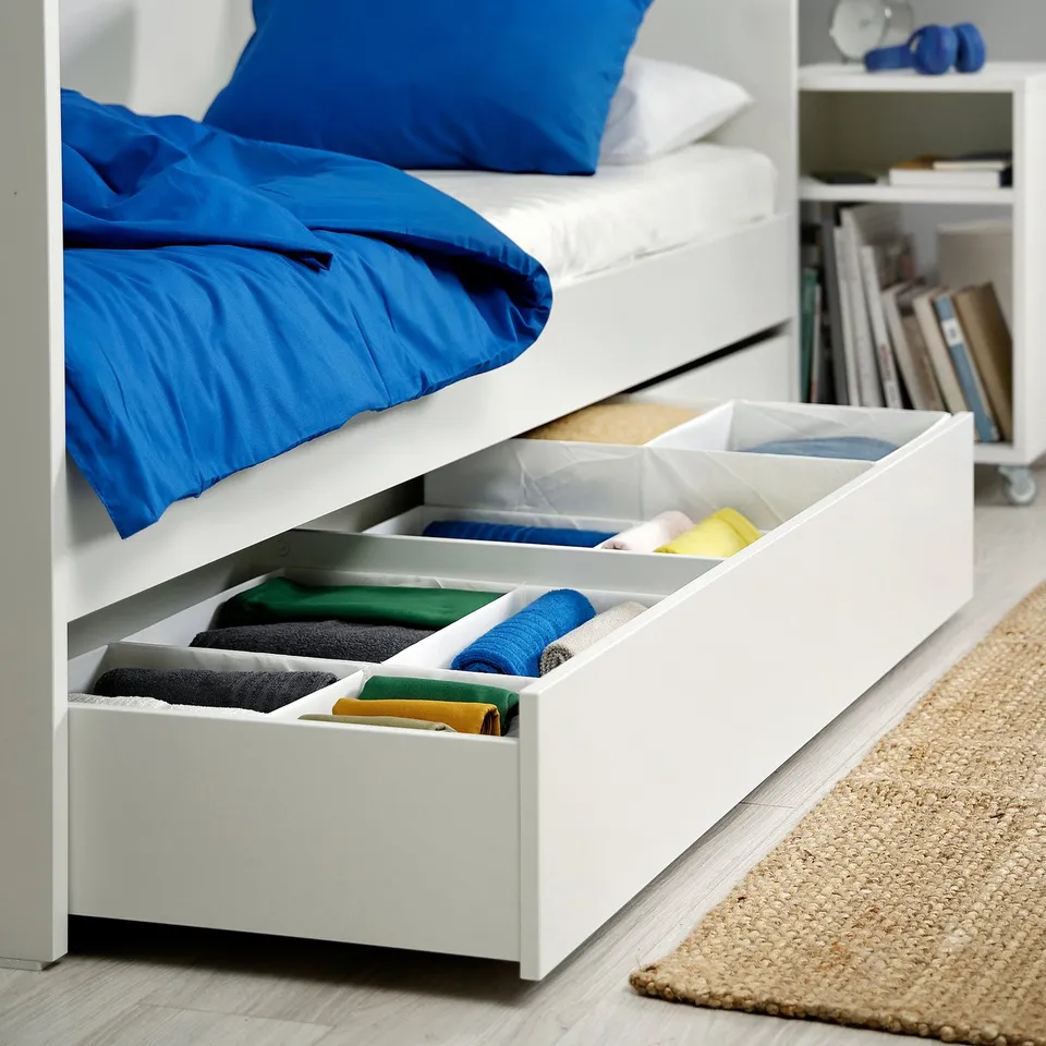Under-bed storage with tidy compartments for linens and clothes.
