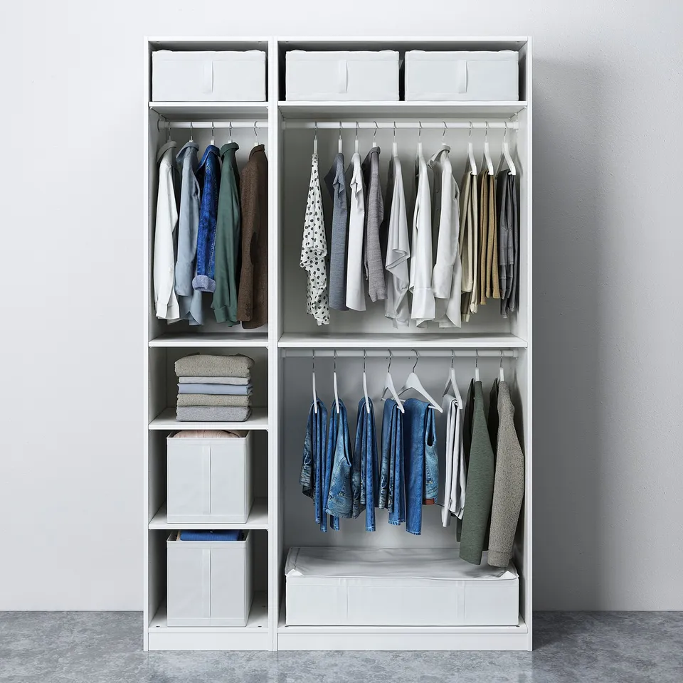 White wardrobe with clothes hangers, folded garments, and storage boxes.