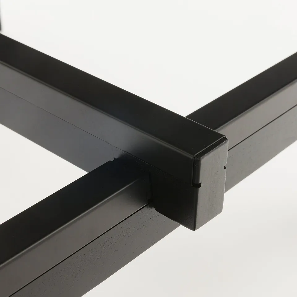 Black metal frame corner with polished edges, showing precision and durability.