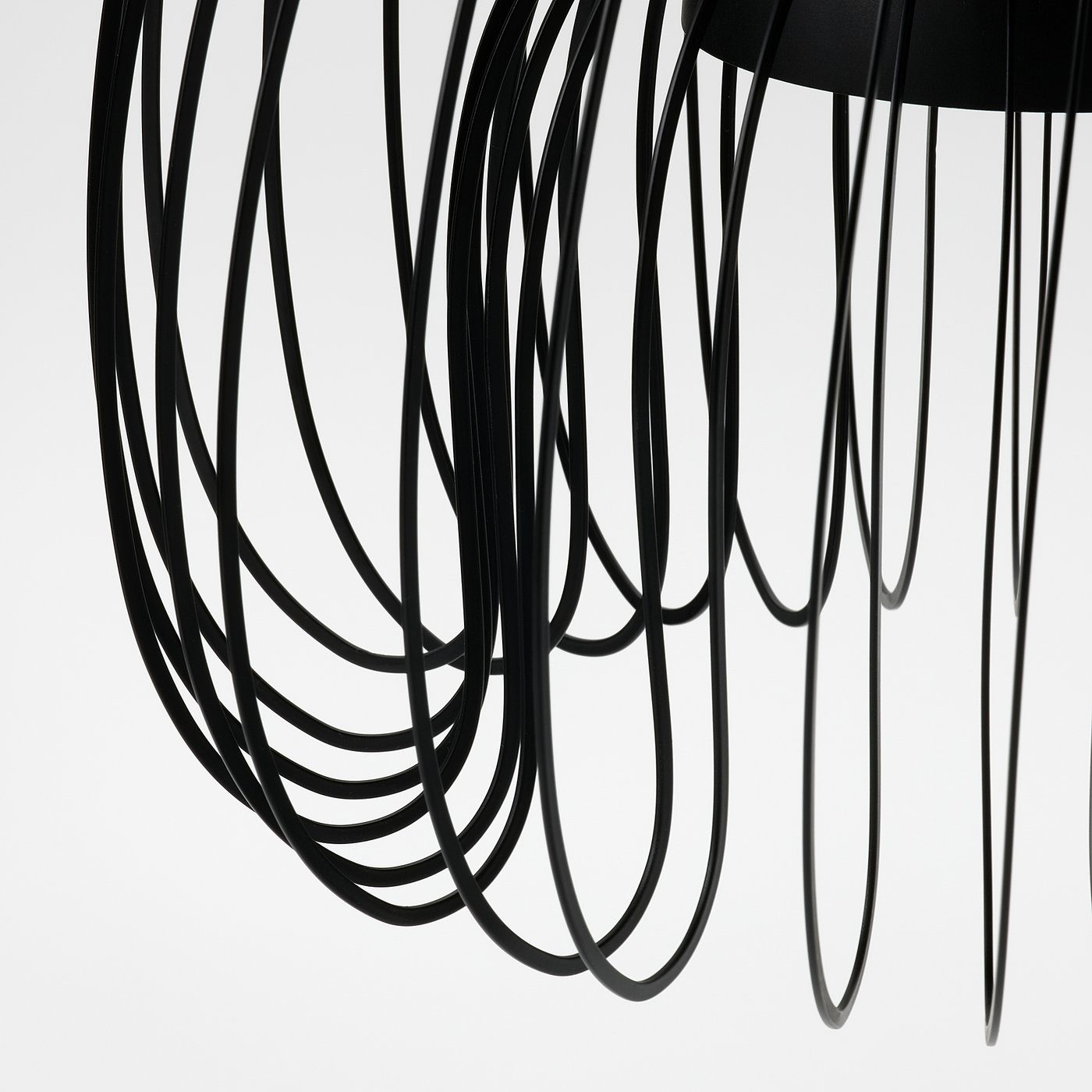 Modern pendant lamp with intricate black wire design, emitting soft, diffused light. Elegant and contemporary, perfect for stylish interiors.