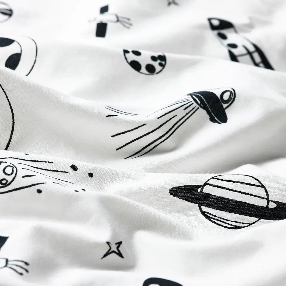 Black & white astronaut and spaceship patterns on soft, white duvet cover fabric.