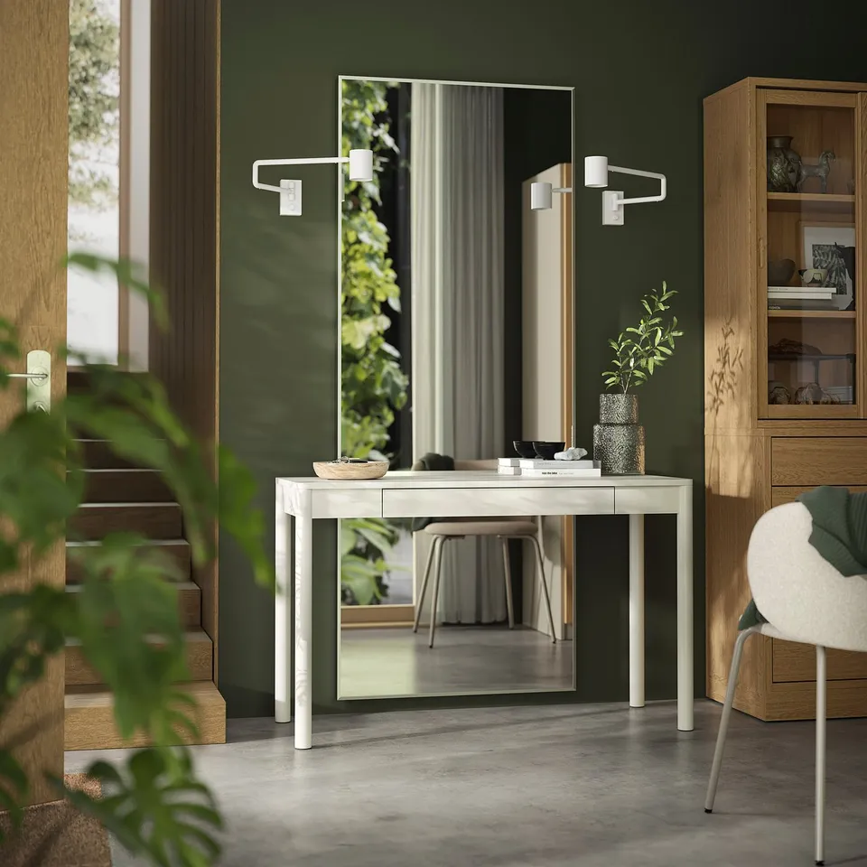 Modern green room with TONSTAD white desk, mirror, chair, and plants.