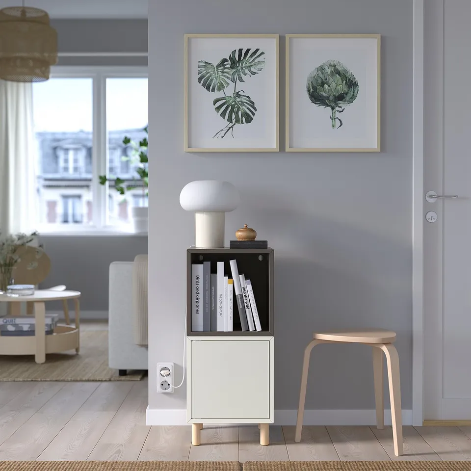 Modern living room with EKET storage, lamp, and plant prints