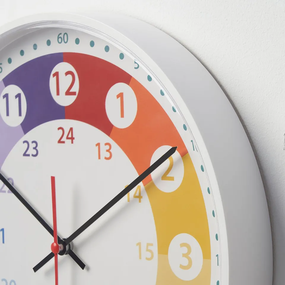 Colourful wall clock with large numbers, 24-hour dial, and distinct colour sections for each quarter, showing current time as 2:15.