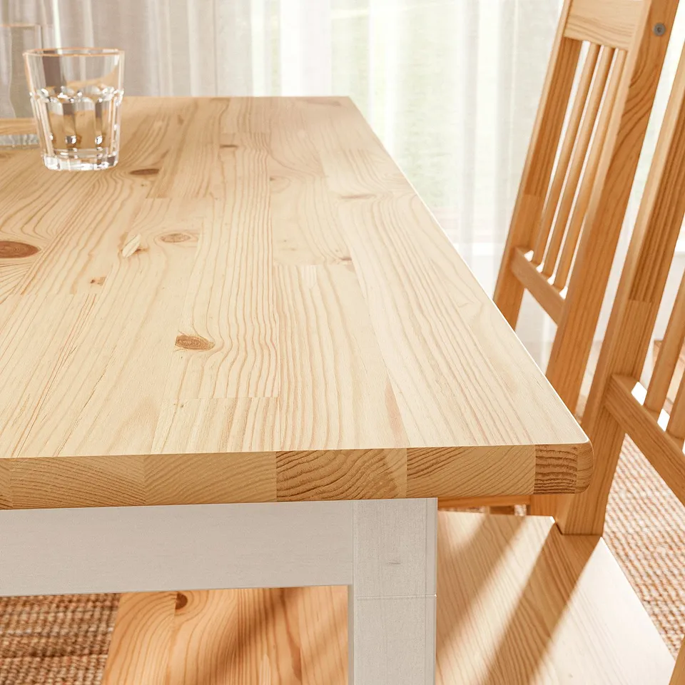 Wooden dining table and chair set, beautifully crafted with natural pine finish, showcasing fine grain detail and sturdy construction.