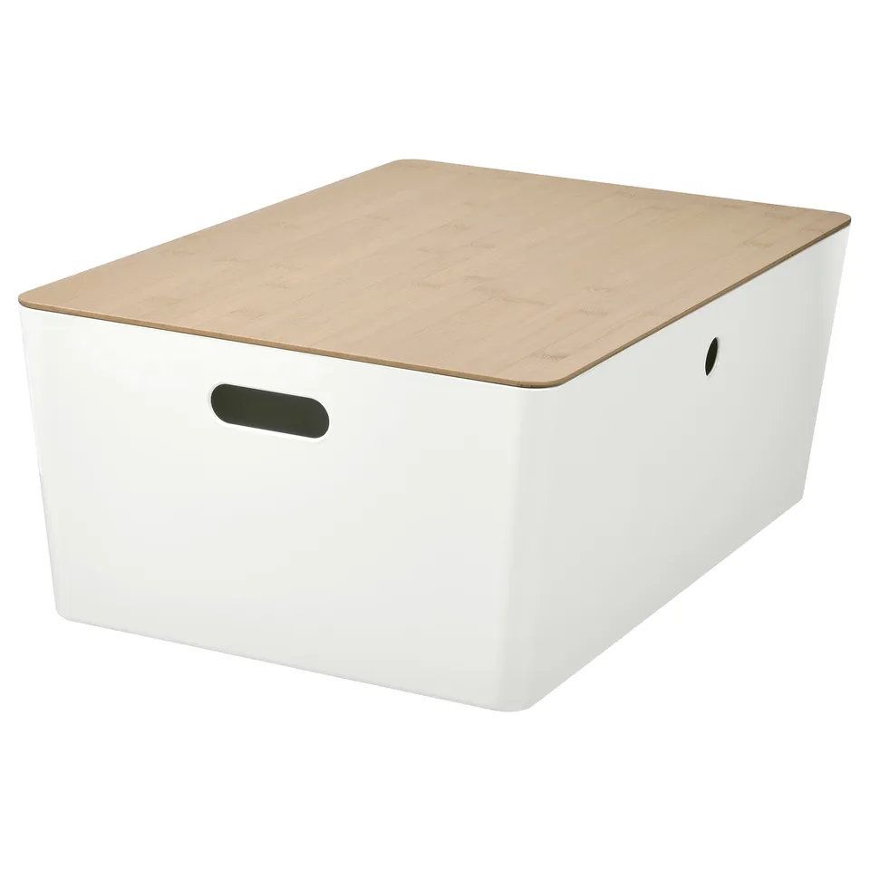 A KUGGIS storage box in white with a wooden lid, designed for organising items like gaming consoles or hobby accessories.