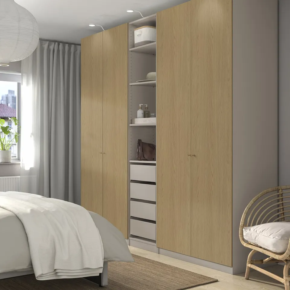 PAX wardrobe, tall, light wood, white accessories, clean lines. Huge, taller than bed, by window.