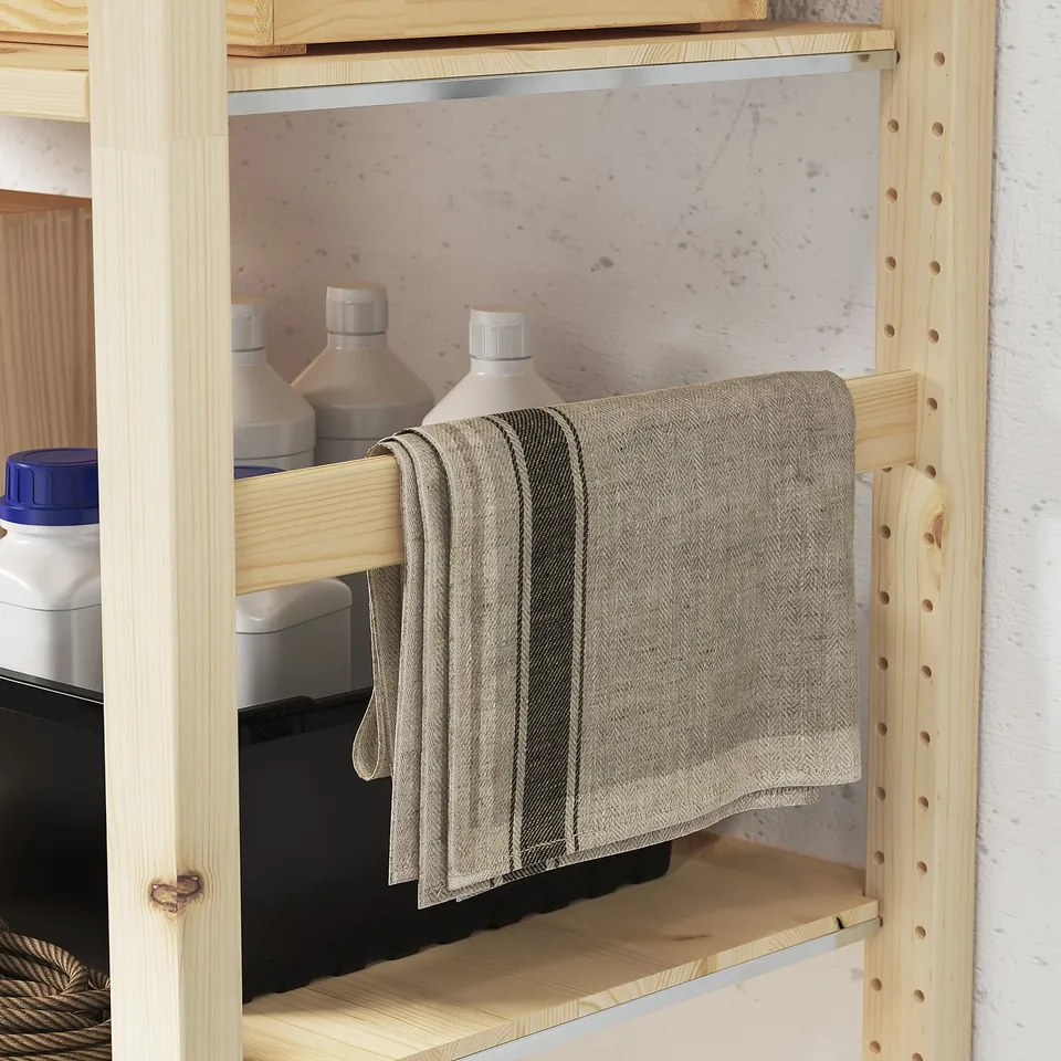Wooden IVAR unit with adjustable shelves, featuring hanging towel. Suitable for various rooms, durable and adaptable.