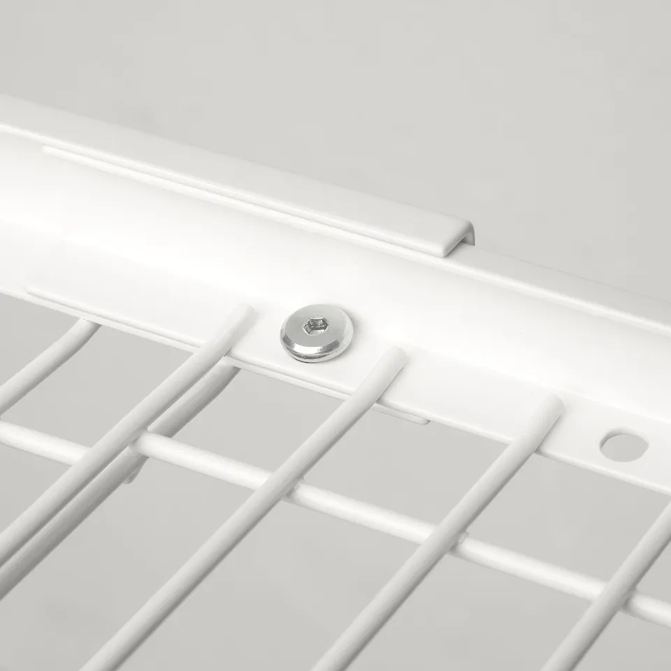 White metal dish drainer with adjustable grid.