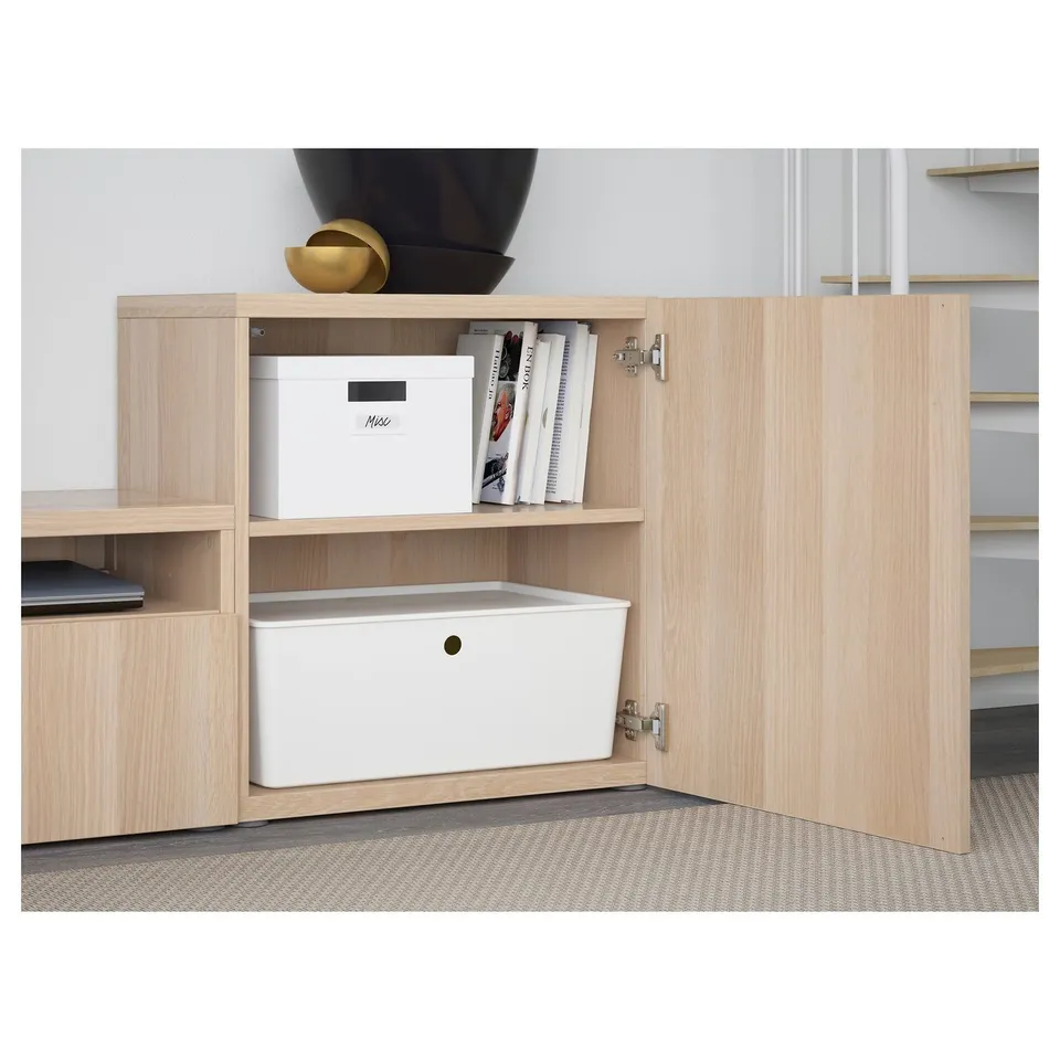 Wooden storage unit with adjustable shelves and drawers, keeping items organised and cables tidy behind the doors.