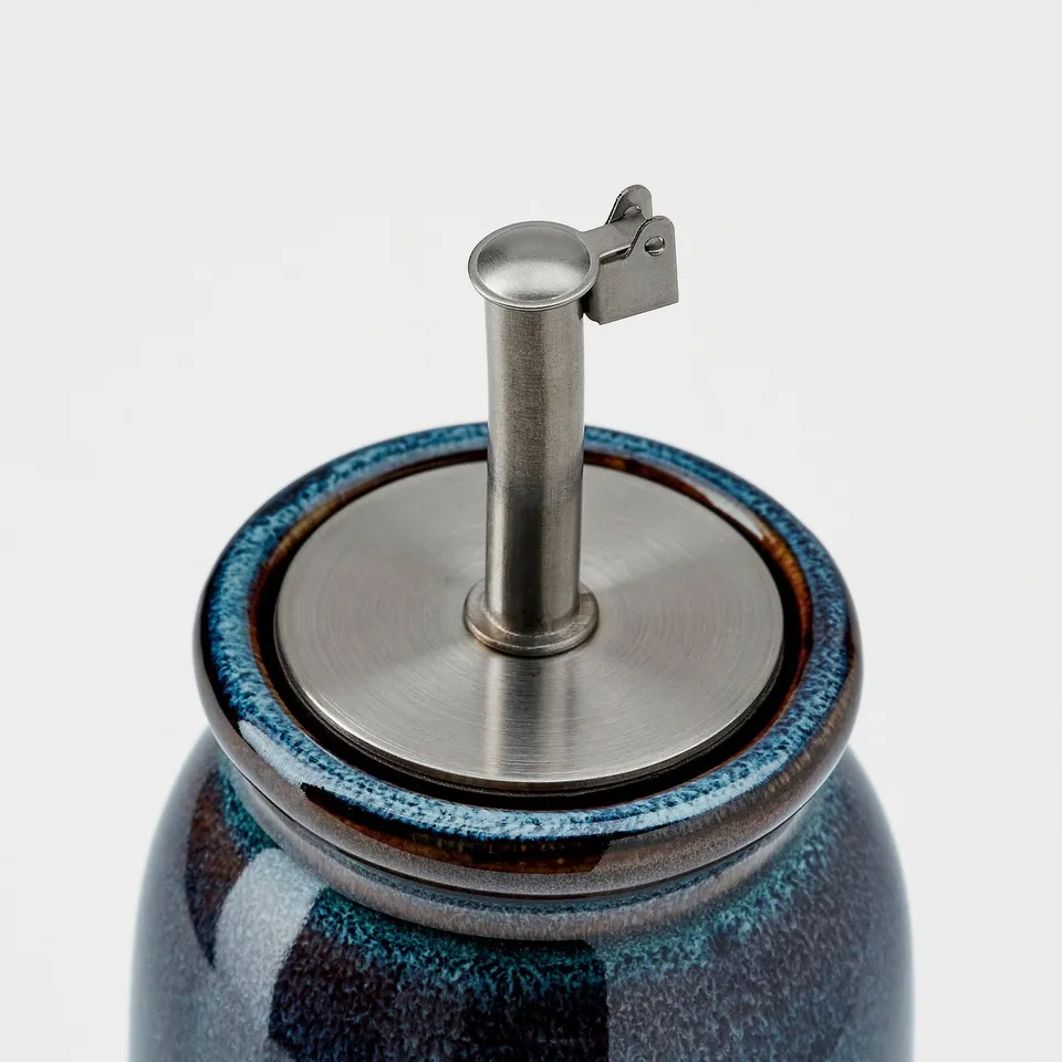 High-quality stoneware bottle with stainless steel lid, secured with silicone seal. Elegant glazed finish.