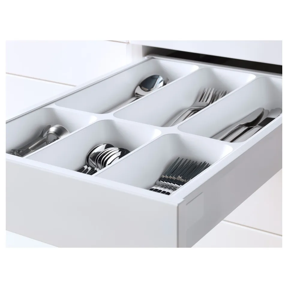 Silverware drawer organiser with compartments for spoons, forks, knives, and other utensils.