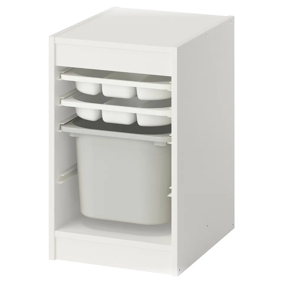 A white TROFAST storage unit with compartments and a large bin, ideal for organising childrens items.