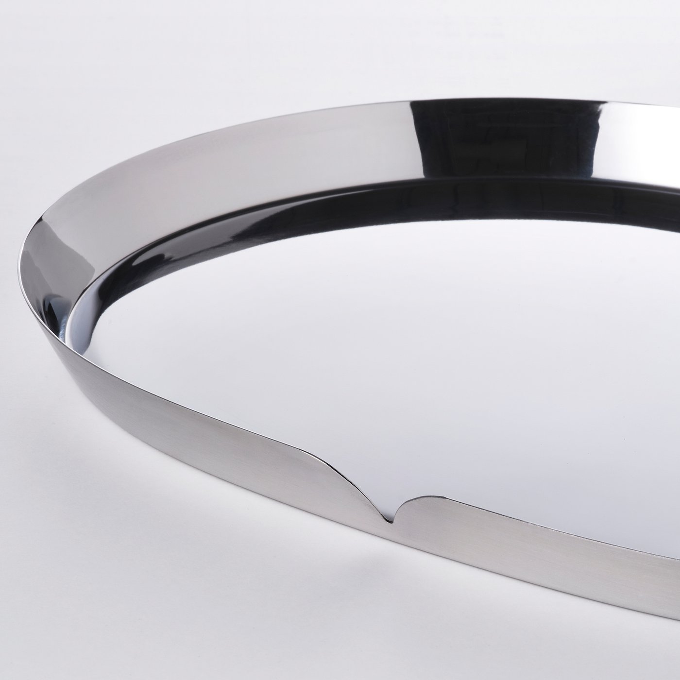 Sleek, polished metallic curve reflects light, showcasing precision crafting.
