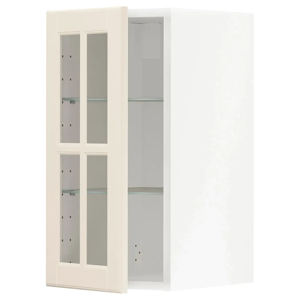 A white METOD kitchen cabinet with glass doors and adjustable shelves.